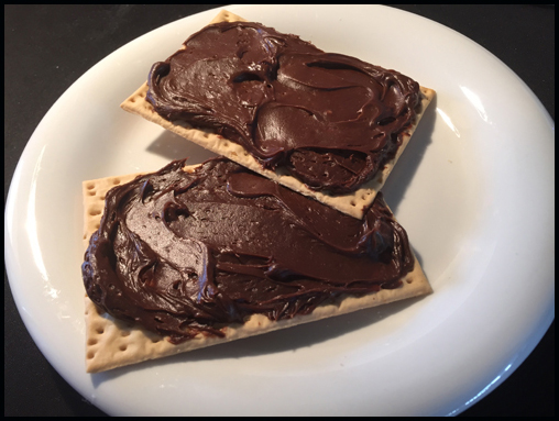 A little leftover birthday cake frosting and a Glutino Table Cracker... a nice pairing ;o).