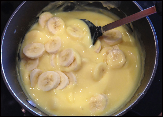 When pudding is almost thickened on stove top, add the remaining banana slices, stirring constantly